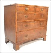 A Georgian late 18th Century oak chest of two short over three long drawers having crossbanded