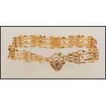 A hallmarked 9ct gold gate bracelet with tapered ends and attached heart-shaped padlock.