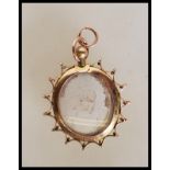 An early 20th Century Edwardian hallmarked 9ct gold mourning / photo panel pendant of oval form