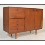 A mid century teak wood Avalon sideboard. Raised on turned legs, the wide and high body with a