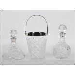 Two hallmarked silver collared cut glass crystal decanters of different form but having same cut