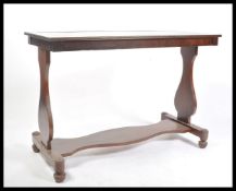 A good Regency revival mahogany and green tooled leather writing table desk being raised on lyre