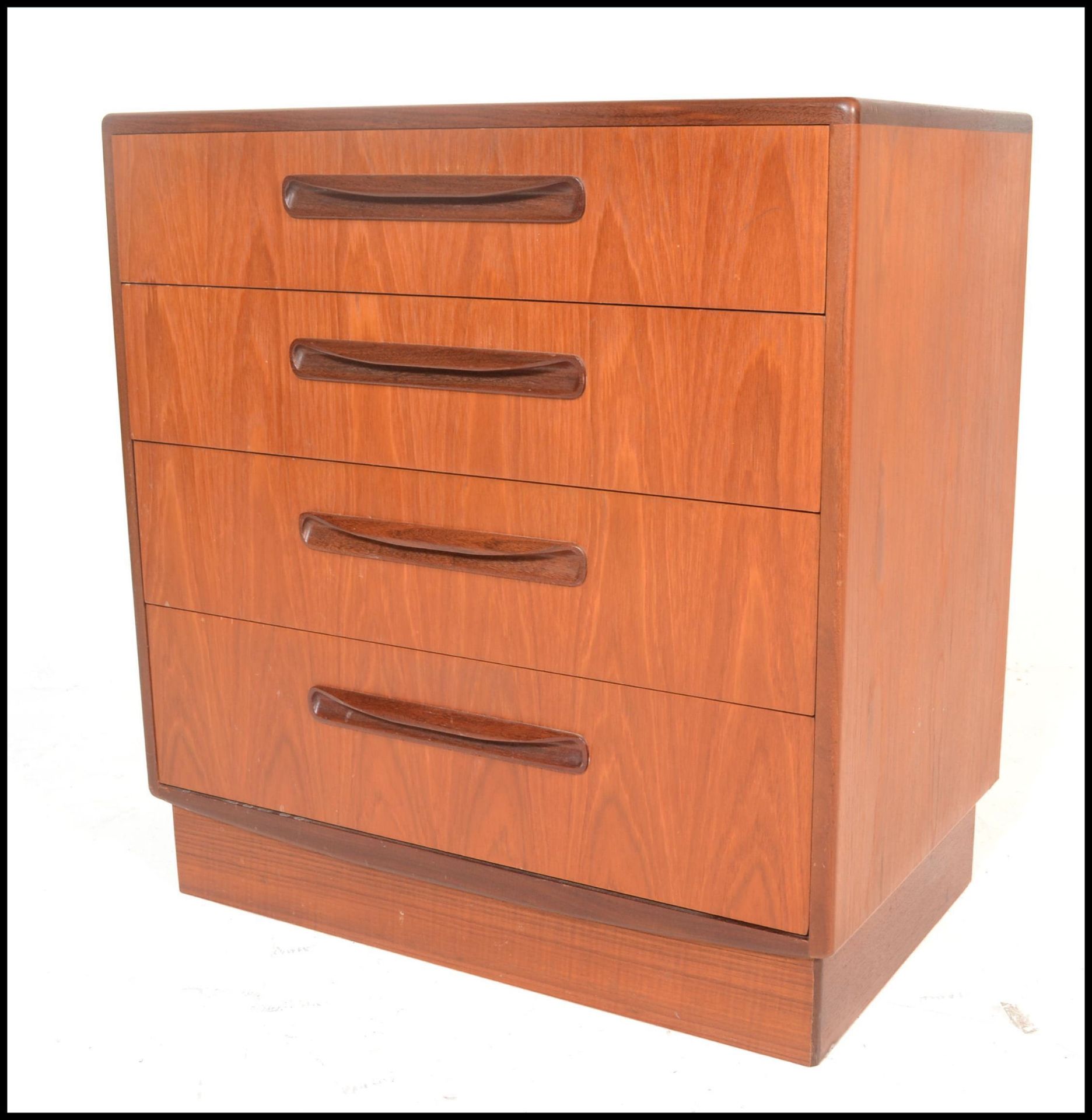 A 1970's G-Plan teak wood Kelso Pattern chest of drawers being raised on an inset plinth with