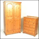 A 20th Century antique style matching pine bedroom suite consisting of a double door wardrobe and