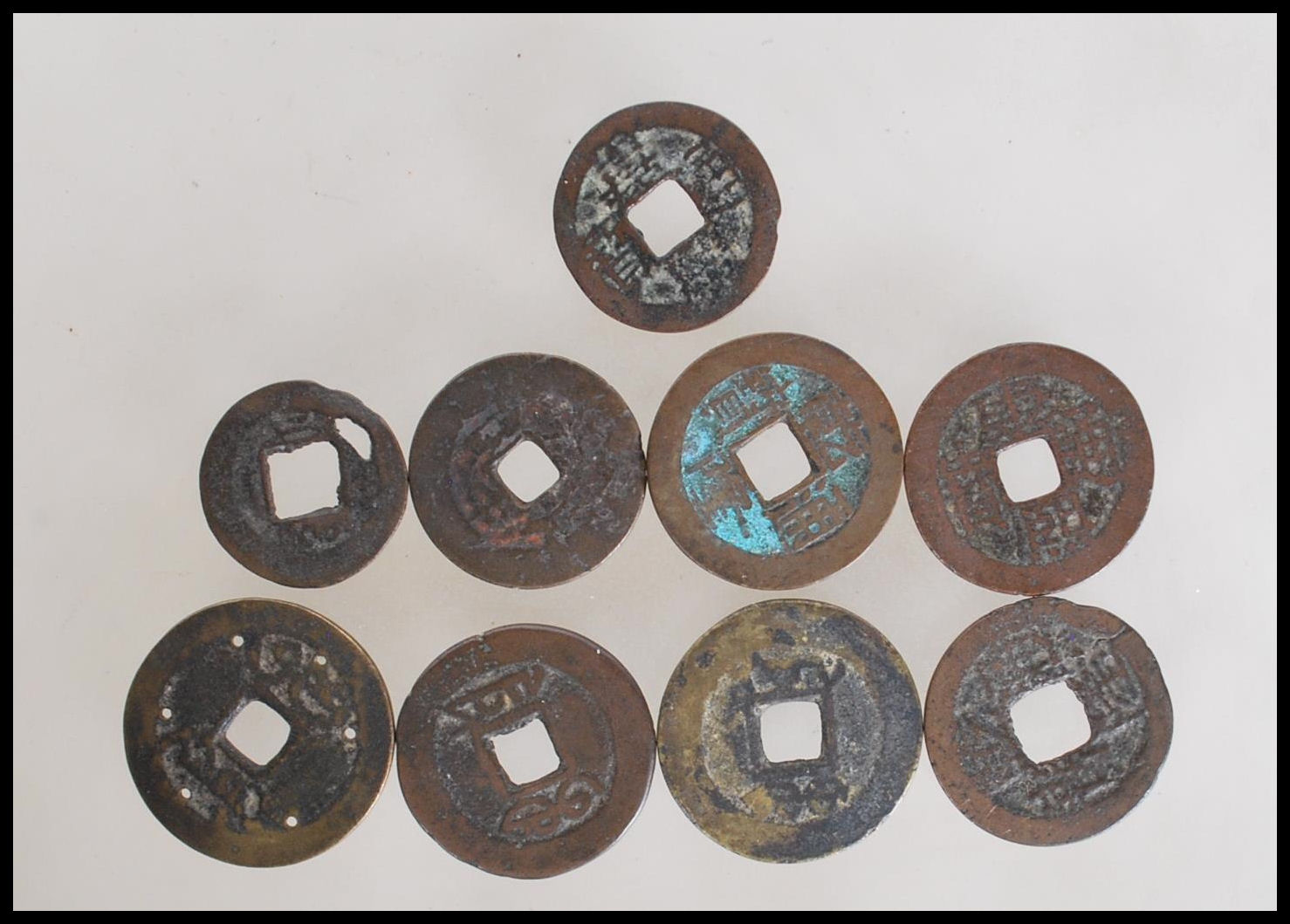 A group of nine Chinese tang dynasty coins having square pierced centres. Nine in total. - Image 5 of 7