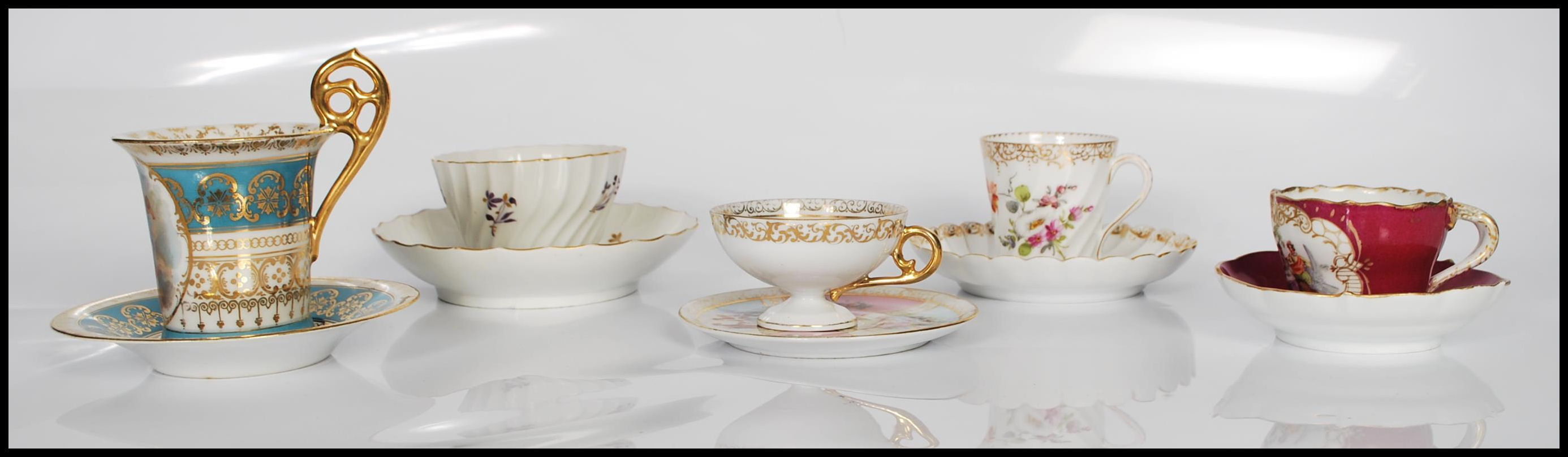 A collection of five late 19th / early 20th Century cabinet cups and saucers to include a hand