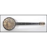 An early 20th Century eight string banjo having a raw hide drum within a wooden case having inlaid
