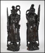 A pair of 20th century Chinese carved hardwood figures of Deity's / Immortals raised on a