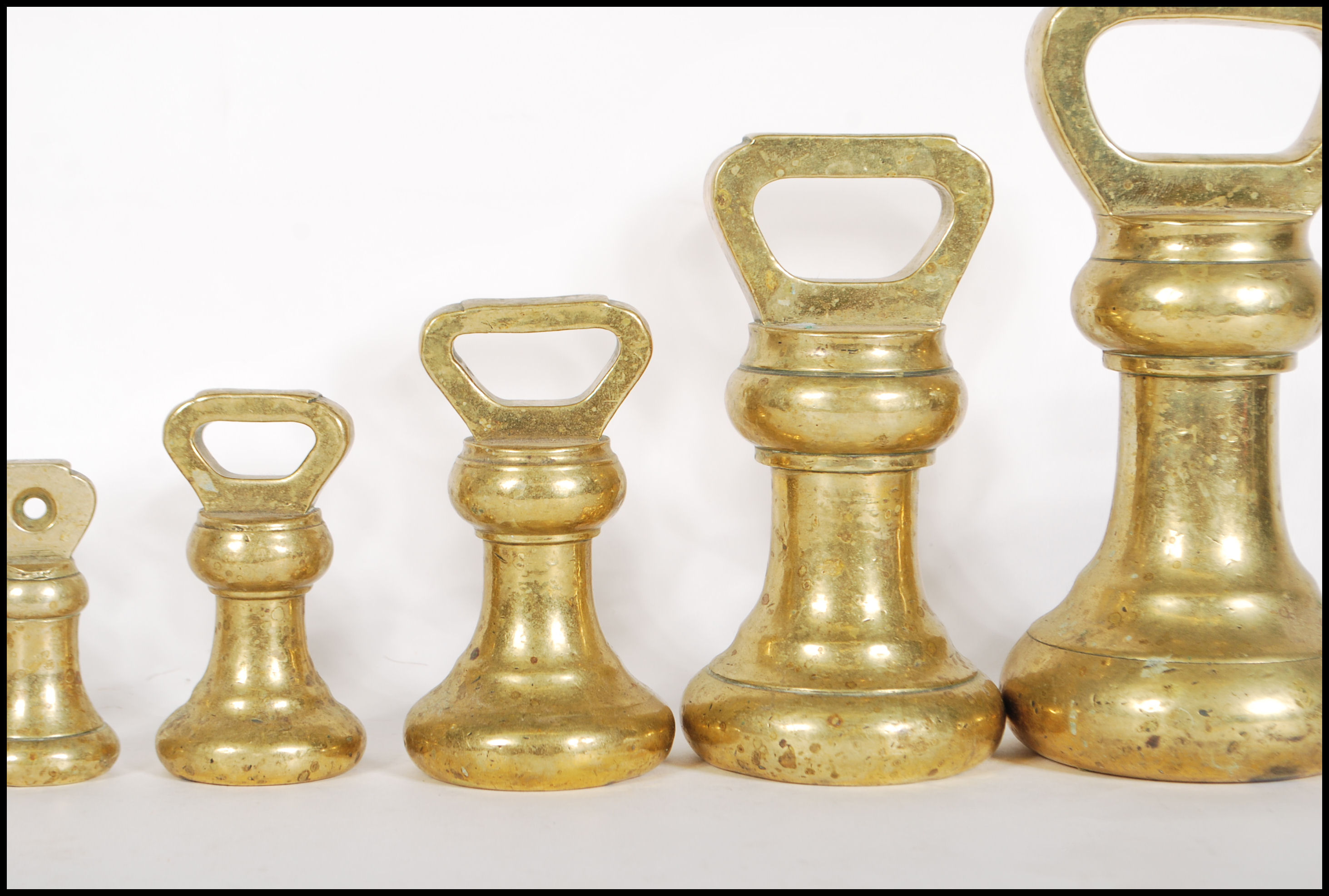 A selection of 20th century graduating brass bell weights having carrying handles atop, with the - Image 3 of 7