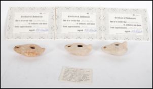 A group of three ancient Roman terracotta oil lamps believed to date from around 300 AD each with