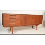 A retro mid  20th Century teak wood sideboard by G-Plan. The double doors with a bank of four