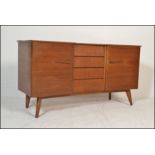 A vintage retro 20th Century teak wood breakfront sideboard credenza, central bank of four drawers