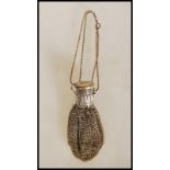 A vintage mid 20th Century white metal chain link bag having an extendable neck with round cap to