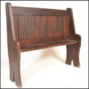 A late 19th /  early 20th Century pine pew / hall settle of simple construction, the raised back