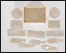 A selection of 19th Century mother of pearl gaming counters to include two round tokens, and five