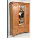 A late 19th / early 20th Century high Victorian light oak single door wardrobe having blind fretwork