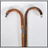 Two early 20th Century walking stick canes having crook handles. One being bamboo with a silver