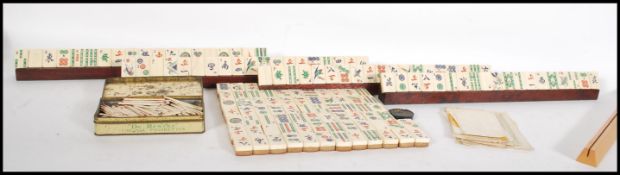 An early 20th century Oriental Mahjong set, the pieces of bone and bamboo construction with four