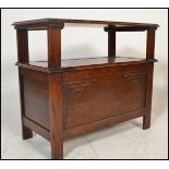 A 1920's oak monks bench / hall settle. Of plain form with stile legs having hinged seat with a fold