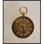 A stamped 18ct gold open faced pocket fob watch having a gilt dial with floral decoration and