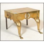 An early 20th Century brass footmans trivet / carriage step having bowed front legs with pierced