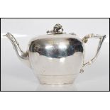 A 19th Century Victorian silver hallmarked teapot of squat circular form having rose finial to the