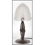 An early 20th Century Secessionist table lamp having hand worked metal base with frosted glass