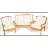 A vintage 20th Century open framed spindle back three piece suite in the manner of Ercol. consisting