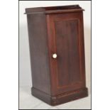 A Victorian 19th century mahogany pot cupboard raised on a plinth base with full length door