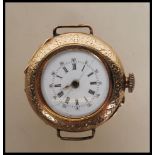 A marked 14ct gold wrist watch having chase decoration to front and verso with central monogrammed