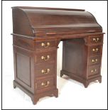 An antique style mahogany roll top tambour fronted childs desk having bracket feet with faux