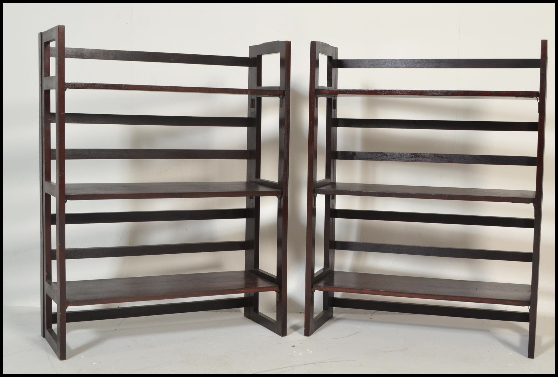 A pair of vintage style 20th Century wooden folding bookcases / traders display shelves. Three