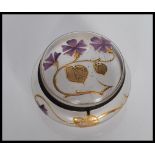 An early 20th Century Art Nouveau glass powder compact, having hinged lid and hand painted gold