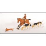 An unusual early 20th century wooden hand painted childs hunting toy set. To include horse and