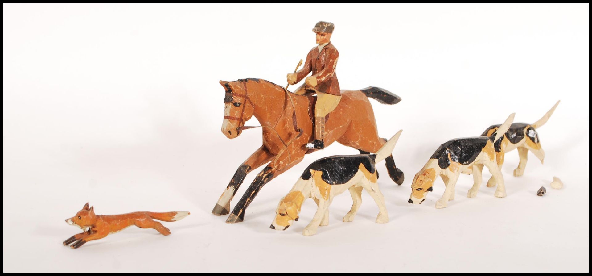 An unusual early 20th century wooden hand painted childs hunting toy set. To include horse and
