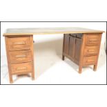 A early 20th Century 1920's Industrial Air Ministry style oak twin pedestal office desk having a