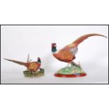 A large ceramic Border Fine Arts pheasant figurine no. A0659 raised on a wooden base together with