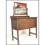 An early 20th Century country oak dressing table chest.  The twin drawers with knob handles with a