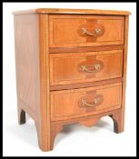 A 20th Century French commode bachelors chest of drawers having rosewood, maple and chestnut