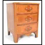 A 20th Century French commode bachelors chest of drawers having rosewood, maple and chestnut