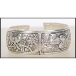 A Chinese silver white metal bangle / bracelet being repousse decorated with ducks, deers, birds and