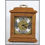 A 20th Century oak cased bracket clock, gilt engraved dial with silver chapter ring, Roman numerals,