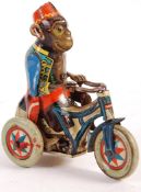 1940'S ARNOLD CLOCKWORK MONKEY ON TRICYCLE