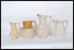 A group of four jugs to include a Doulton Lambeth