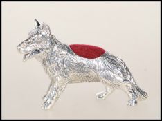 A silver German Shepherd Dog pin cushion. The dog