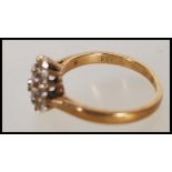 A hallmarked 9ct gold and diamond cluster ring. Ha