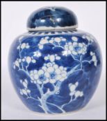 A Chinese ginger jar being hand painted in blue an