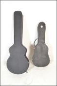 Two black faux leather guitar cases one having red