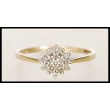 A hallmarked 9ct gold and diamond cluster ring. Ha