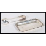 A silver hallmarked card tray and silver pair of t